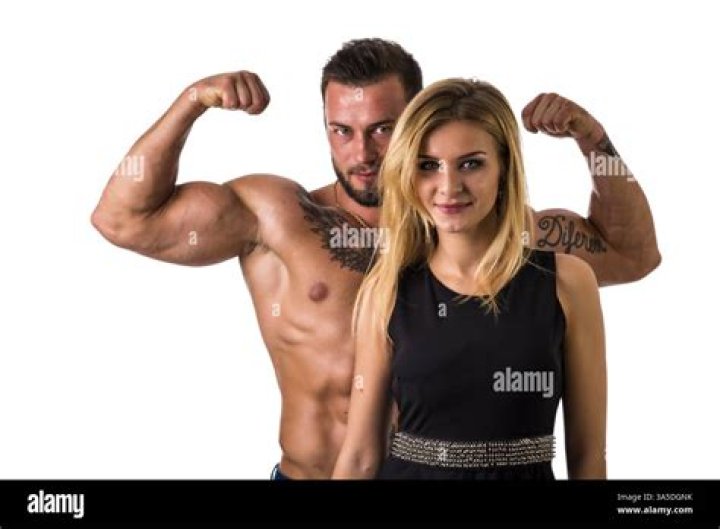 a man and woman posing for the camera at an event